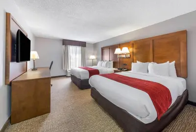 a hotel room with two beds and a flat screen tv at Comfort Inn Grove City - Columbus South in Grove City