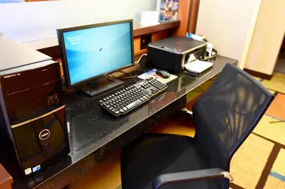 a desk with a computer monitor and a printer at Fairfield Inn & Suites by Marriott Weirton in Weirton