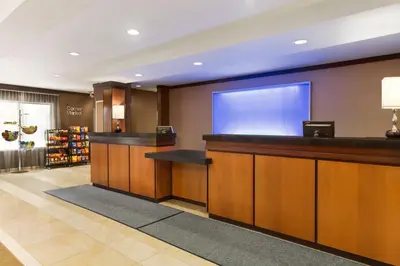 a hotel lobby with a large screen on the wall at Fairfield Inn & Suites by Marriott Weirton in Weirton
