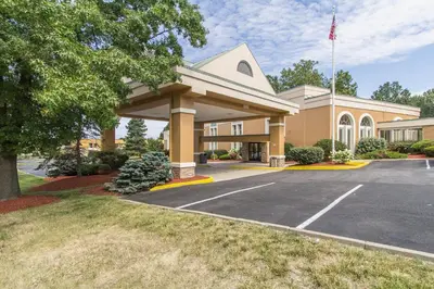 a building with a parking lot in front of it at GreenRidge Hotel in Wickliffe