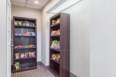 a walk in pantry with two shelves filled with food at GreenRidge Hotel in Wickliffe