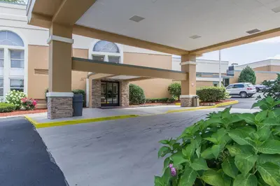 a front view of a building with a parking lot at GreenRidge Hotel in Wickliffe