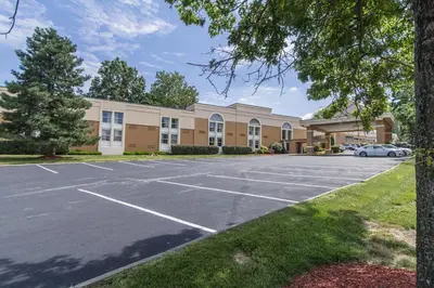 a parking lot in front of a building at GreenRidge Hotel in Wickliffe