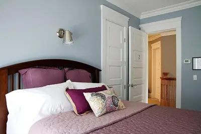 a bedroom with a bed with purple walls at Wishmaker House B&b in Bellville