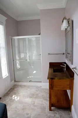 a bathroom with a shower with a sink and a mirror at Wishmaker House B&b in Bellville