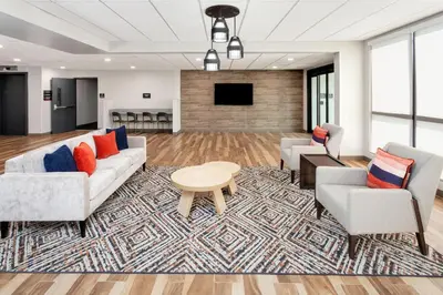 a living room with two couches and a tv at Candlewood Suites Columbus North - Worthington by IHG in Columbus