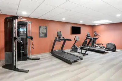 a gym with three tread machines in a room at Candlewood Suites Columbus North - Worthington by IHG in Columbus