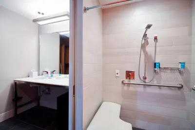 a bathroom with a shower and a toilet and a sink at Aloft Cleveland Airport in North Olmsted