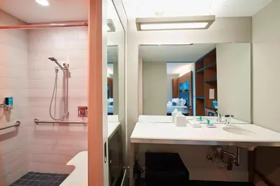 a bathroom with a sink and a shower at Aloft Cleveland Airport in North Olmsted