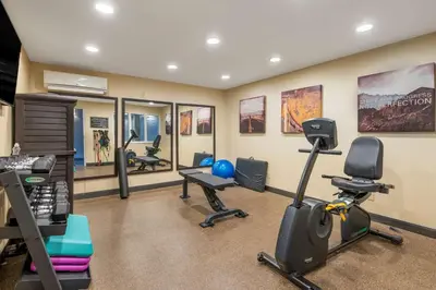 a gym with tread machines and exercise equipment in a room at Best Western Hilliard Inn & Suites in Hilliard