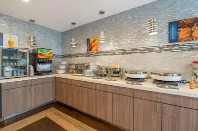 a kitchen with a counter with some pots and pans at Best Western Hilliard Inn & Suites in Hilliard