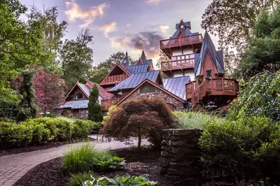 a large wooden house with a blue roof at Landoll's Mohican Castle in Loudonville