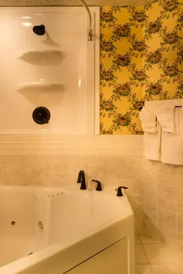 a bathroom with a white sink and a mirror at Landoll's Mohican Castle in Loudonville