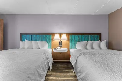 a hotel room with two beds and a table at Hampton Inn Cleveland-Westlake in Westlake