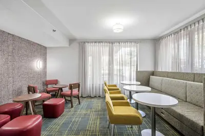 a waiting room with tables and chairs and a couch at Hampton Inn Cleveland-Westlake in Westlake