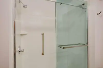 a glass shower stall with a glass door at Hampton Inn & Suites Cleveland-Independence in Independence