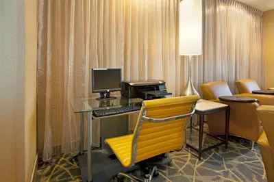 a room with a desk with a computer and a yellow chair at Hampton Inn & Suites Cleveland-Independence in Independence