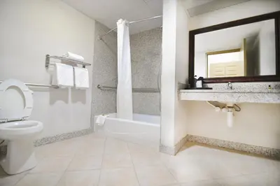 a bathroom with a tub and a toilet and a sink at Best Western Plus Sandusky Hotel & Suites in Sandusky