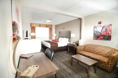 a hotel room with a bed and a couch at Best Western Plus Sandusky Hotel & Suites in Sandusky