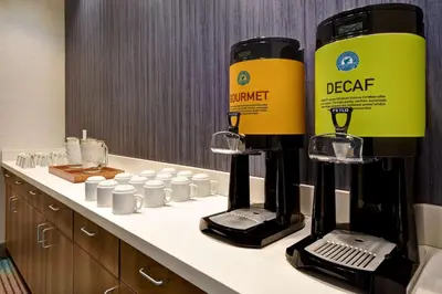 a hotel bathroom with two coffee machines on a counter at Home2 Suites By Hilton Bowling Green, Oh in Bowling Green
