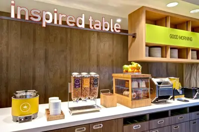 a coffee shop with a prepared table on a counter at Home2 Suites By Hilton Bowling Green, Oh in Bowling Green