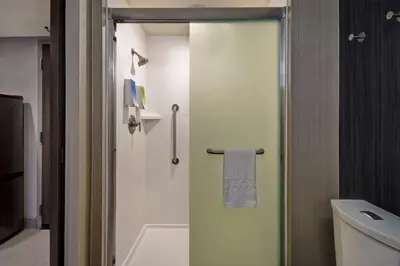 a bathroom with a shower with a glass door at Home2 Suites By Hilton Bowling Green, Oh in Bowling Green