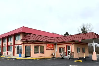 a gas station with a red roof at Red Carpet Inn & Suites Lima -Listing Partner in Lima