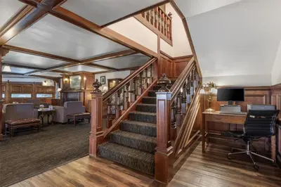 a spiral staircase in a home with a desk and chair at SureStay Plus Hotel by Best Western Auburn in Auburn
