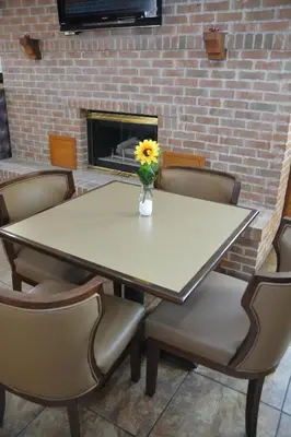 a table and chairs with a vase with a sunflower on it at Quality Inn & Suites Dublin in Dublin