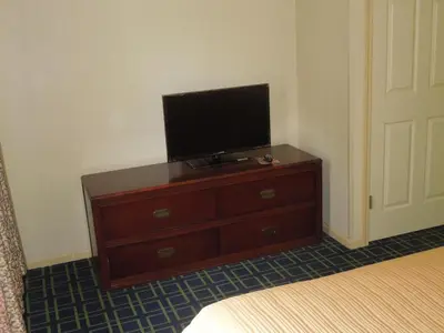 a bedroom with a dresser with a television on it at Quality Inn & Suites Dublin in Dublin