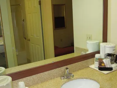 a bathroom counter with a sink and a mirror at Quality Inn & Suites Dublin in Dublin
