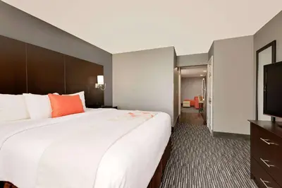 a hotel room with a large bed and a flat screen tv at Hawthorn Extended Stay by Wyndham Columbus West in Columbus