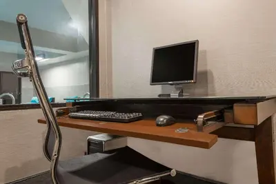 a desk with a computer monitor and a keyboard at Hawthorn Extended Stay by Wyndham Columbus West in Columbus