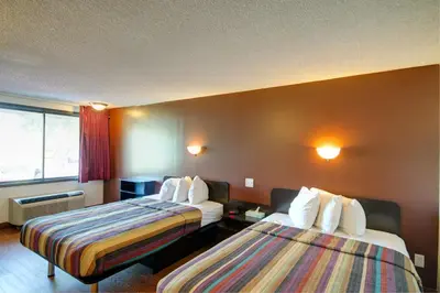 a hotel room with two beds and a window at Americas Best Value Inn Heath-Newark in Heath