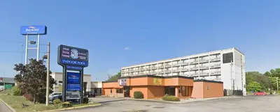 a gas station in front of a large building at Baymont by Wyndham Youngstown in Youngstown