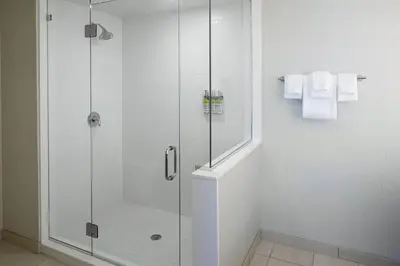 a bathroom with a shower with a glass door at Holiday Inn Express & Suites - Cincinnati North - Liberty Way by IHG in West Chester