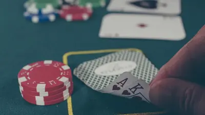 a person holding a pair of poker chips on a table at Holiday Inn Express & Suites - Cincinnati North - Liberty Way by IHG in West Chester