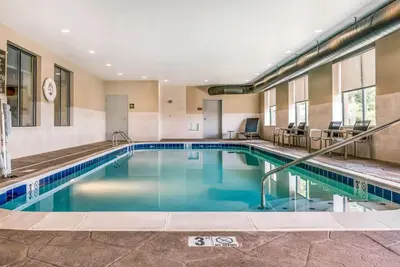 a swimming pool with blue water in a hotel at Comfort Suites Florence - Cincinnati South in Florence