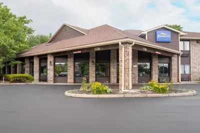 a store front of a building with flowers in front at Baymont by Wyndham Delaware in Delaware