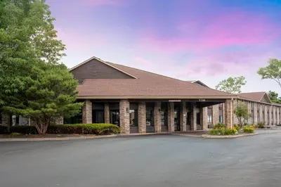 a large building with a parking lot in front of it at Baymont by Wyndham Delaware in Delaware