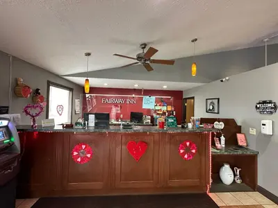 a restaurant with a counter with red decorations at Fairway Inn Florence Indiana in Florence