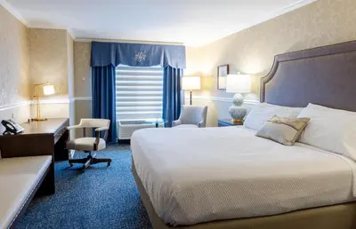 a hotel room with a bed and a desk and chair at The Glidden House in Cleveland