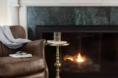 a glass of wine on a table next to a fireplace at The Glidden House in Cleveland