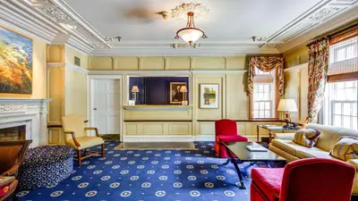a living room filled with furniture and a fireplace at The Glidden House in Cleveland
