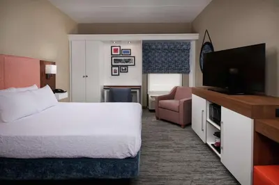 a hotel room with a bed and a flat screen tv at Hampton Inn by Hilton Youngstown-West I-80 in Mineral Ridge