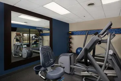 a gym with tread machines and a mirror at Hampton Inn by Hilton Youngstown-West I-80 in Mineral Ridge