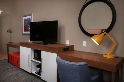 a room with a desk with a tv and a mirror at Hampton Inn by Hilton Youngstown-West I-80 in Mineral Ridge