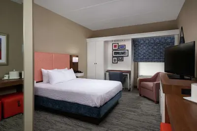 a hotel room with a bed and a flat screen tv at Hampton Inn by Hilton Youngstown-West I-80 in Mineral Ridge