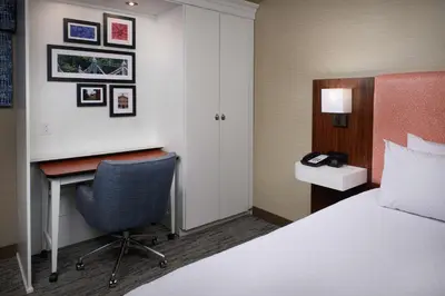 a hotel room with a bed and a desk and a chair at Hampton Inn by Hilton Youngstown-West I-80 in Mineral Ridge