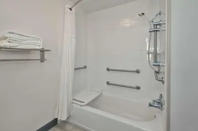 a bathroom with a tub and a shower with a toilet at Hilton Garden Inn Dayton/ Beavercreek in Beavercreek